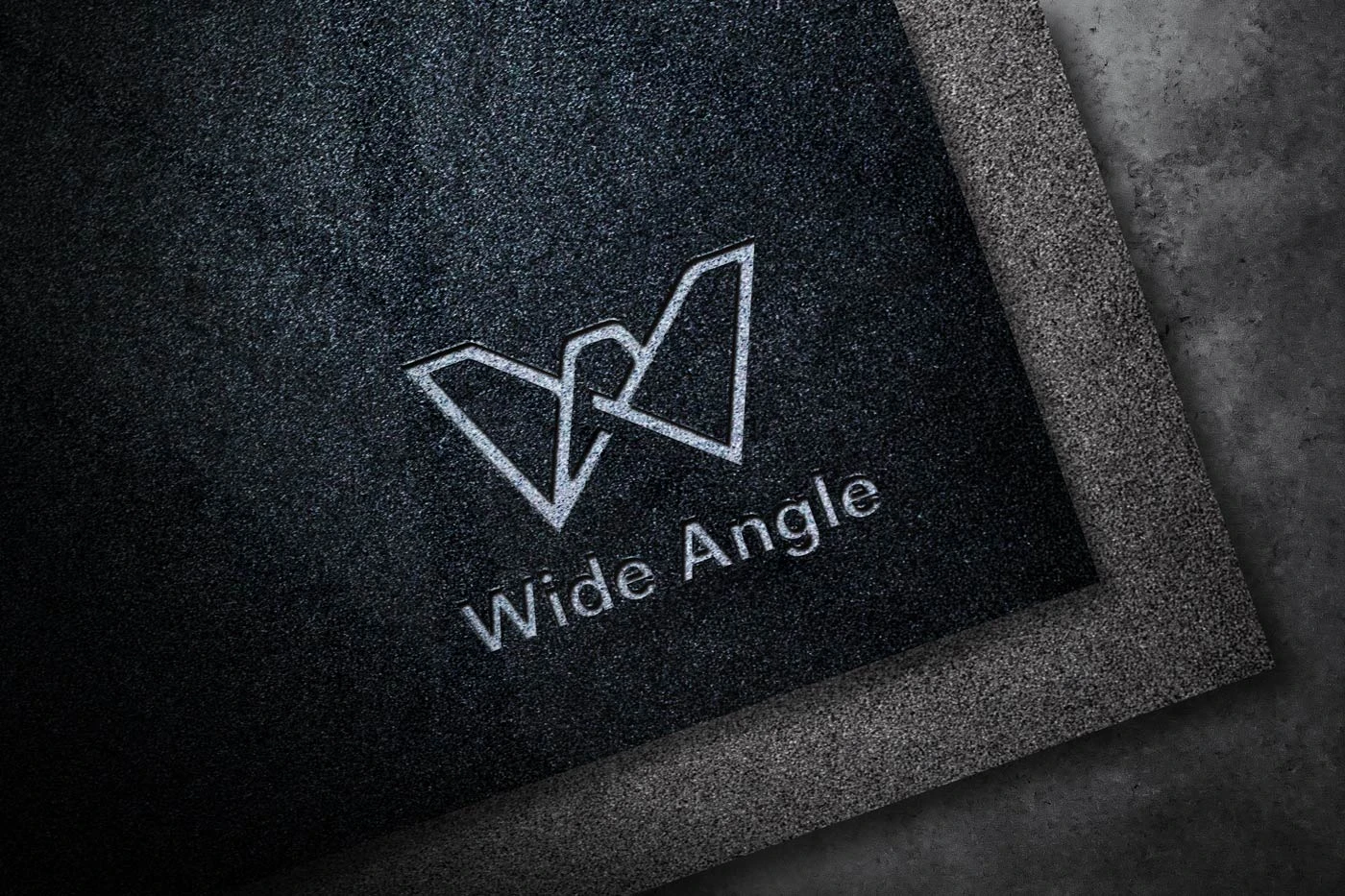 Wide Angle logo embossed on a dark textured surface